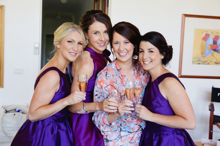 bride-with-her-bridesmaids-relaxing-with-a-champagne